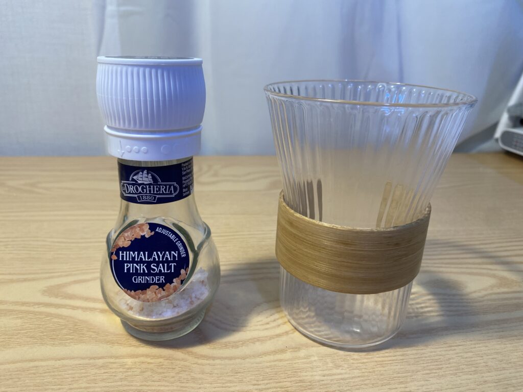 Close-up texture of raw, ethical Himalayan pink salt crystals rich in electrolytes and 84 minerals, compared to refined table salt.