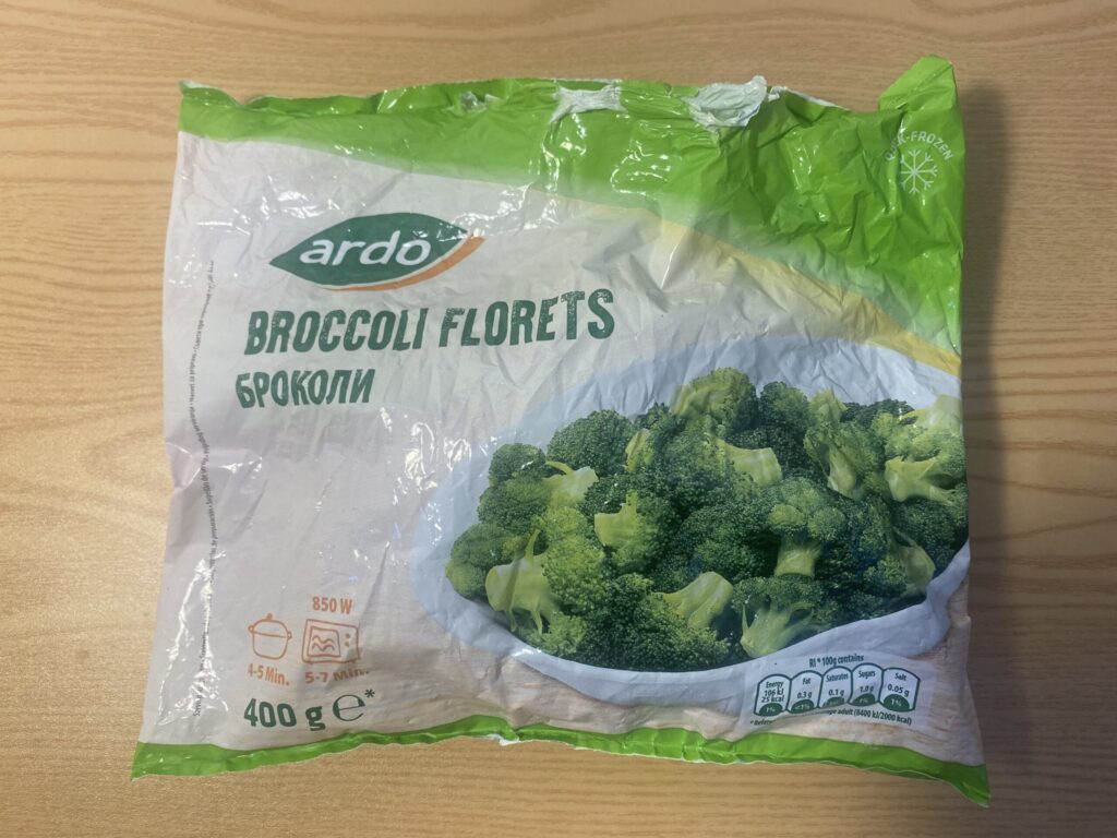 A bag of frozen broccoli florets, which requires mustard seed powder to reactivate the enzyme myrosinase for sulforaphane absorption.