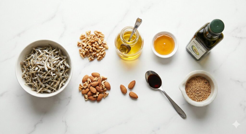 잔멸치, 호두, 아몬드, 들기름, 꿀, 간장 등 바이오해킹 멸치볶음 레시피를 위해 정확히 계량된 원재료 모음.