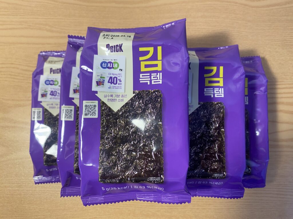 Stack of crisp dried seaweed sheets (Gim) by a window, representing a natural source of iodine for thyroid health and metabolism.