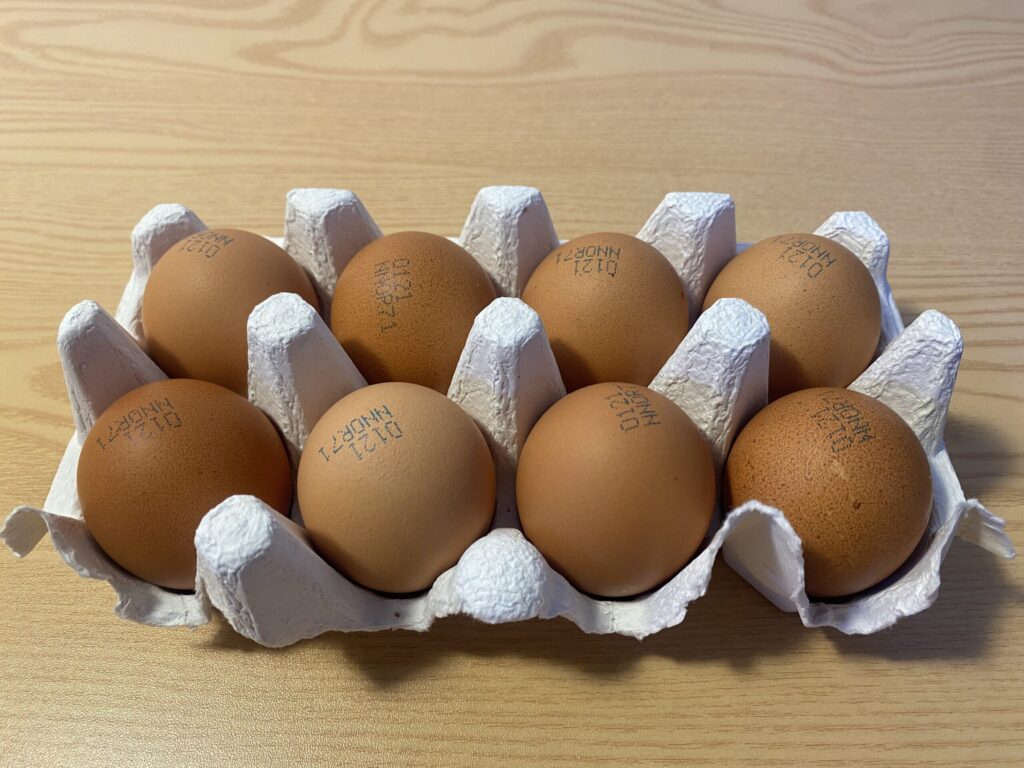 "Close-up of a brown egg with the number 1 stamped on the shell, indicating pasture-raised quality for biohacking diets."