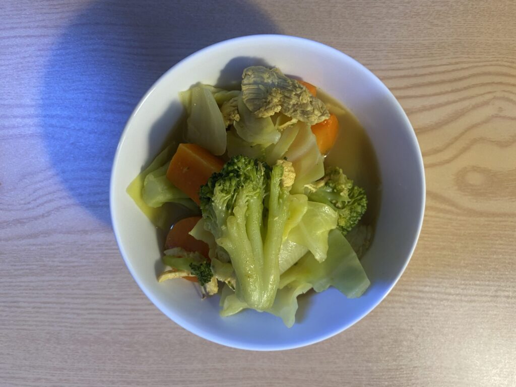 Fresh diced chicken breast, organic turmeric powder, and colorful vegetables prepared for a biohacking anti-inflammatory curry.