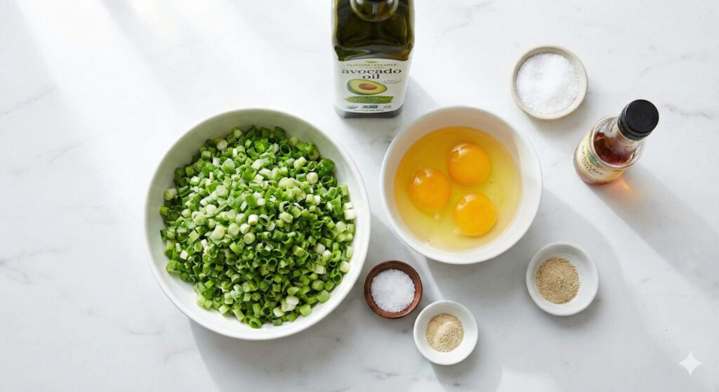 Fresh biohacking ingredients for an immune-boosting stir-fry, featuring chopped green scallions, pasture-raised eggs, avocado oil, and sea salt.