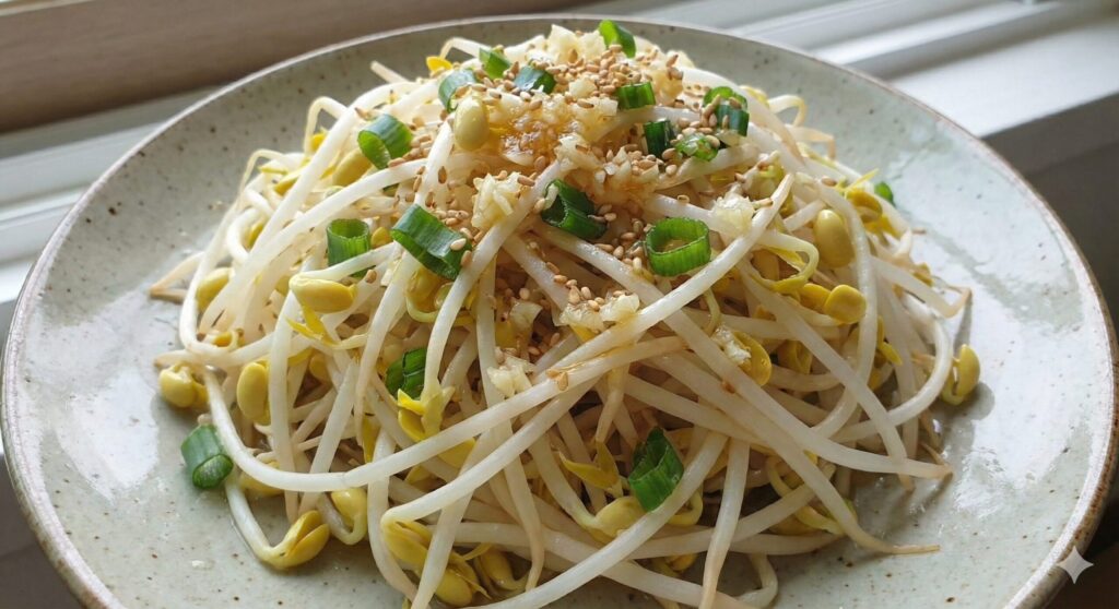 A Korean style mung bean sprout salad (Namul) seasoned with minced garlic and raw perilla oil, representing a liver detox biohacking meal.
