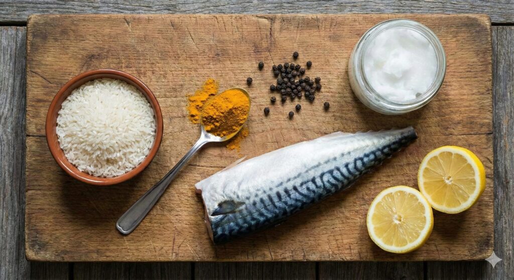 Raw biohacking ingredients including uncooked rice, turmeric powder, black peppercorns, coconut oil, a fresh mackerel fillet, and a lemon.