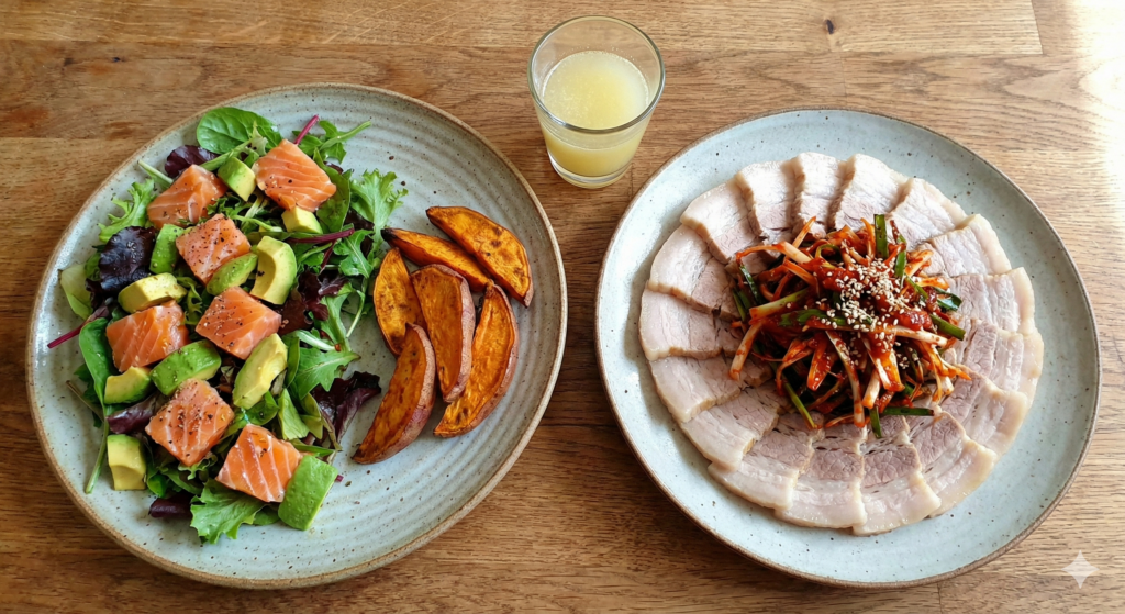 A nutritious daily biohacking meal featuring a fresh salmon avocado salad and a warm plate of boiled pork topped with spicy scallion chili oil salad.